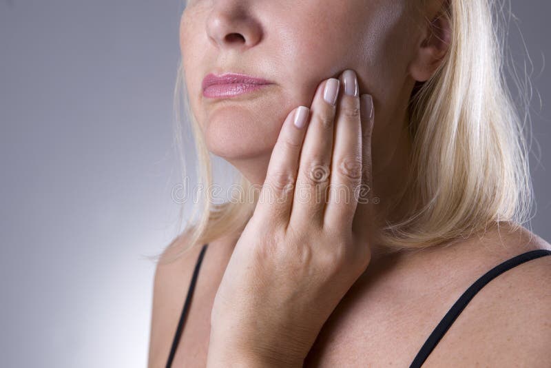 Aged woman with toothache, teeth pain closeup on gray background. Aged woman with toothache, teeth pain closeup on gray background