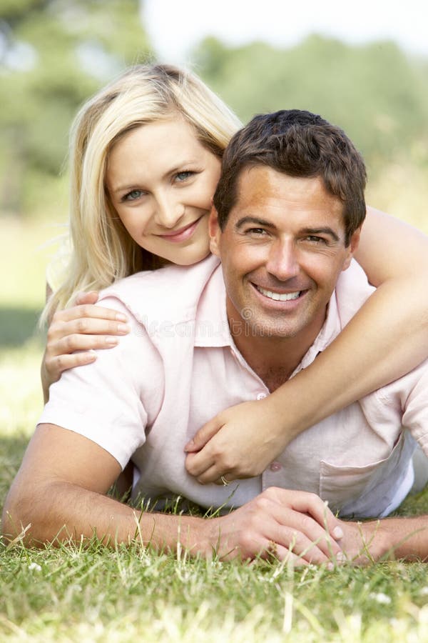 Young couple having fun in countryside lying down and smiling. Young couple having fun in countryside lying down and smiling