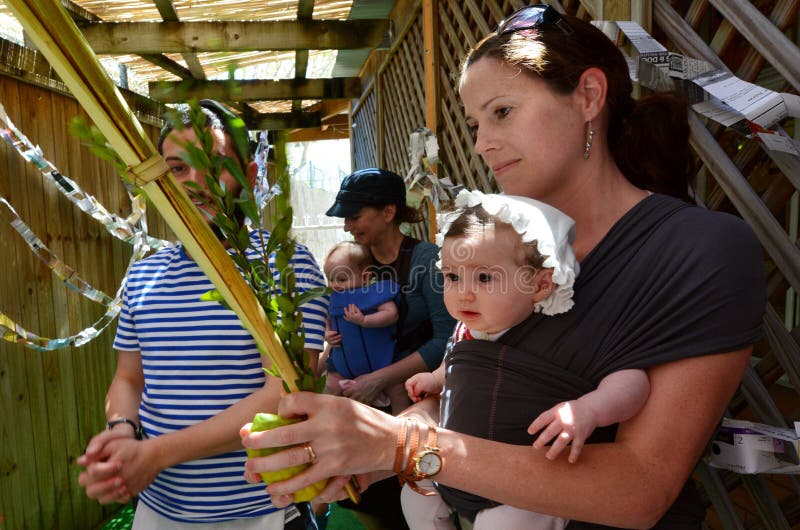 GOLD COAST - OCT 12 2014:Jewish people blessing on the four spices in a Sukkah on Sukkot Jewish Holiday.There are about 100,000 Jewish Australians they are 0.3 percent of the Australian population. GOLD COAST - OCT 12 2014:Jewish people blessing on the four spices in a Sukkah on Sukkot Jewish Holiday.There are about 100,000 Jewish Australians they are 0.3 percent of the Australian population.