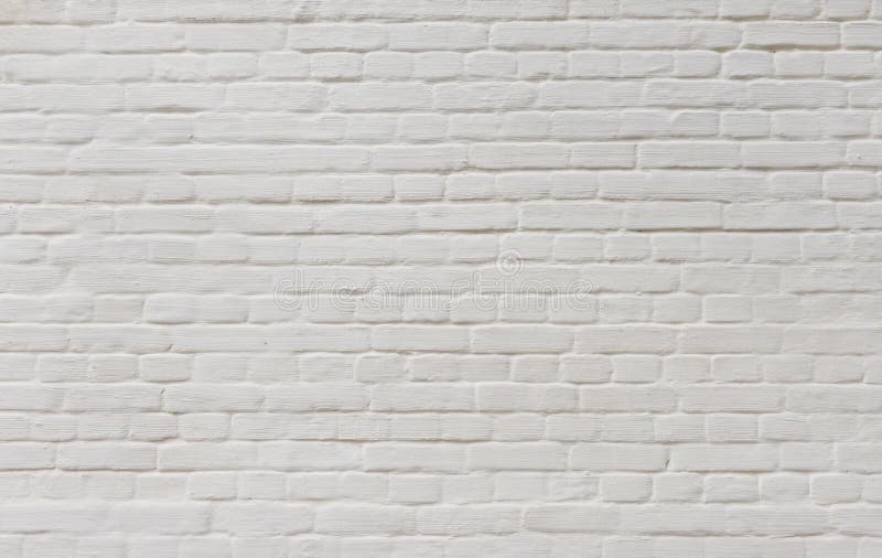 Предпосылка винтажной кирпичной стены покрытая с белым гипсолитом