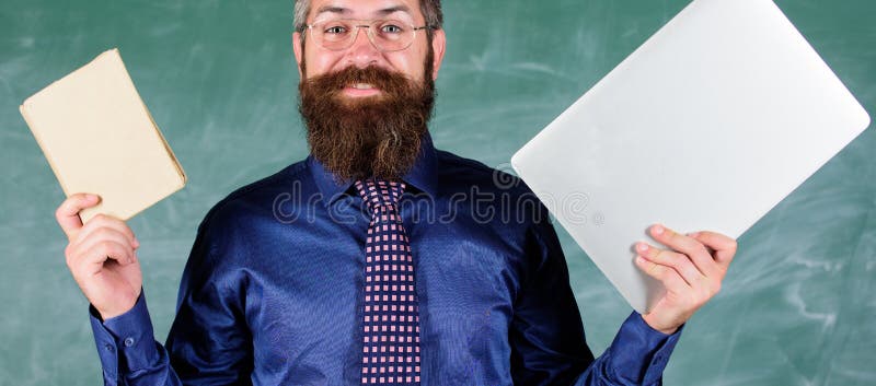 Stay modern with technology. Teacher bearded hipster holds book and laptop. Choose right teaching method. Teacher choosing modern teaching approach. Modern technologies benefit. Digital against paper. Stay modern with technology. Teacher bearded hipster holds book and laptop. Choose right teaching method. Teacher choosing modern teaching approach. Modern technologies benefit. Digital against paper.