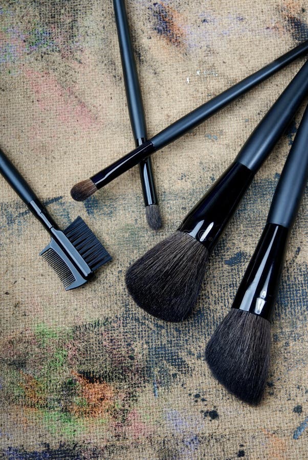 Close-up photo of five brushes on a dingy background. Close-up photo of five brushes on a dingy background