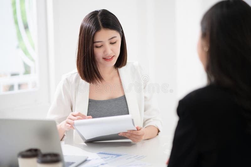 Beautiful asian business women is reading the resume and gives the interview as a human resource for company recruitment with an. Interviewee in a white office as a background, adult, application, attractive, boss, businesswoman, candidate, career, communication, concept, confident, conversation, corporate, desk, discussion, employee, employment, executive, female, girl, group, happy, job, manager, meeting, occupation, paper, people, person, professional, sitting, smile, smiling, success, suit, talking, team, teamwork, worker, working, workplace, young. Beautiful asian business women is reading the resume and gives the interview as a human resource for company recruitment with an. Interviewee in a white office as a background, adult, application, attractive, boss, businesswoman, candidate, career, communication, concept, confident, conversation, corporate, desk, discussion, employee, employment, executive, female, girl, group, happy, job, manager, meeting, occupation, paper, people, person, professional, sitting, smile, smiling, success, suit, talking, team, teamwork, worker, working, workplace, young