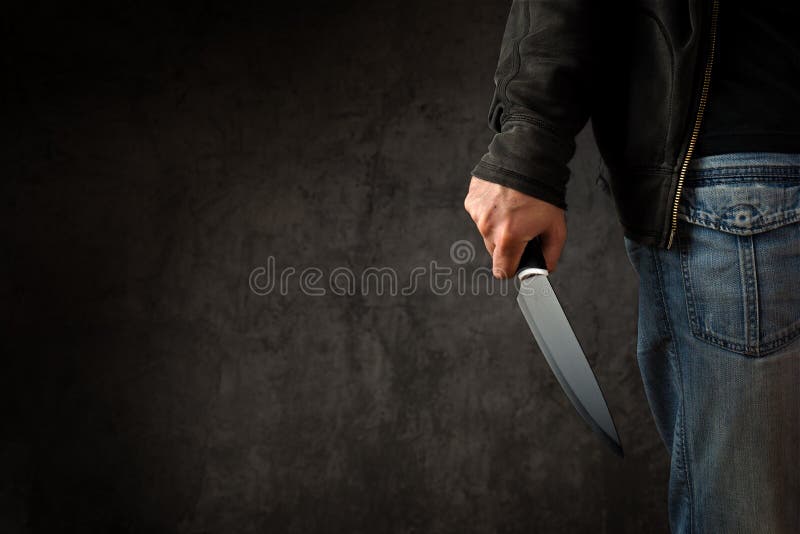 Evil criminal with large sharp knife ready for robbery or to commit a homicide. Evil criminal with large sharp knife ready for robbery or to commit a homicide