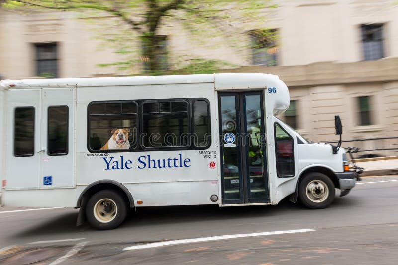 Yale Shuttle Bus in motion in New Haven, CT, USA. Yale is a private Ivy League research university and was founded in 1701. The bulldog depicted on the bus is Yale`s mascot called `Handsome Dan`. Yale Shuttle Bus in motion in New Haven, CT, USA. Yale is a private Ivy League research university and was founded in 1701. The bulldog depicted on the bus is Yale`s mascot called `Handsome Dan`.