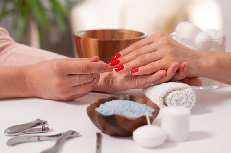 Принципиальная схема Manicure Ногти красивого wiith руки ` s женщины красные в курорте стоковые изображения Принципиальная схема Manicure Ногти красивого wiith руки ` s женщины красные в курорте стоковые изображения