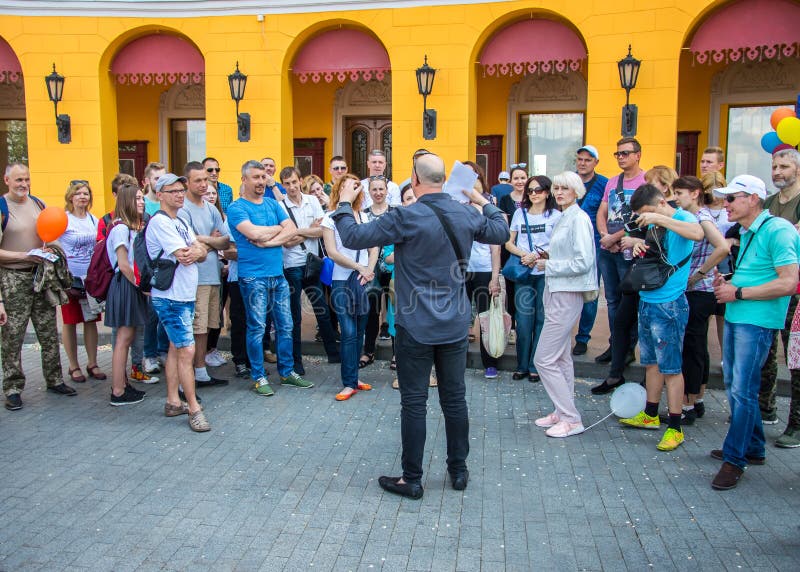 The guide tells the story of the city. Tourists standing around it. Odessa City, Ukraine, May 2019, people, summer, architecture, background, building, center, child, culture, day, erfurt, europe, european, excursion, famous, female, friends, group, happy, journey, lifestyle, man, modern, monument, old, outdoor, recreation, rest, road, school, side, square, street, sun, sunny, support, tourism, town, travel, trip, urban, vacation, view, white, woman, young. The guide tells the story of the city. Tourists standing around it. Odessa City, Ukraine, May 2019, people, summer, architecture, background, building, center, child, culture, day, erfurt, europe, european, excursion, famous, female, friends, group, happy, journey, lifestyle, man, modern, monument, old, outdoor, recreation, rest, road, school, side, square, street, sun, sunny, support, tourism, town, travel, trip, urban, vacation, view, white, woman, young