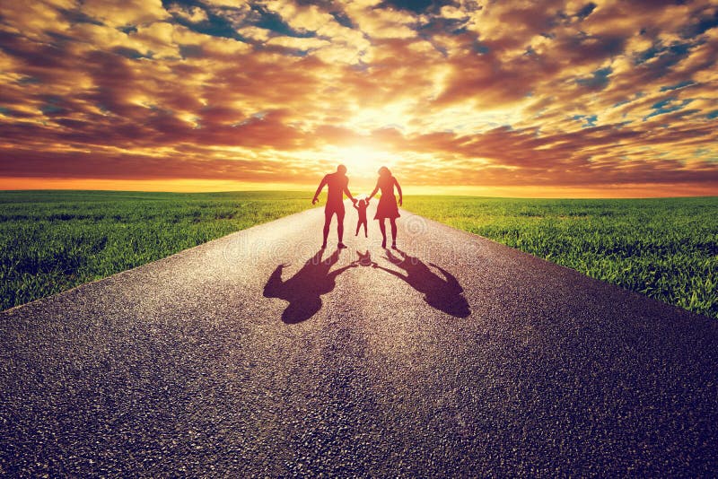 Family walk on long straight road, way towards sunset sun. Mother, father and child. Parenthood concepts. Family walk on long straight road, way towards sunset sun. Mother, father and child. Parenthood concepts