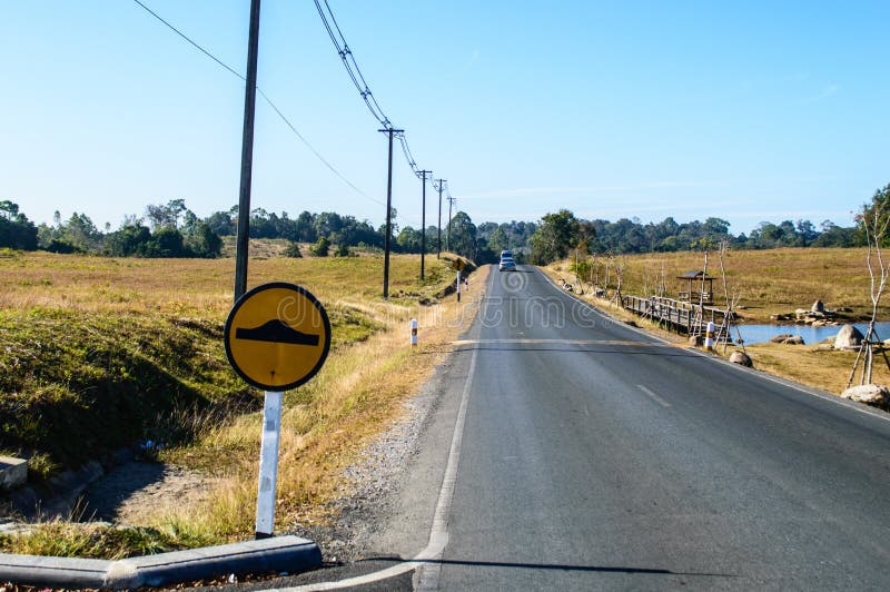 Country local road between on a sunny summer day. Remote location with little traffic 2 lanes sealed road providing access. Country local road between on a sunny summer day. Remote location with little traffic 2 lanes sealed road providing access.