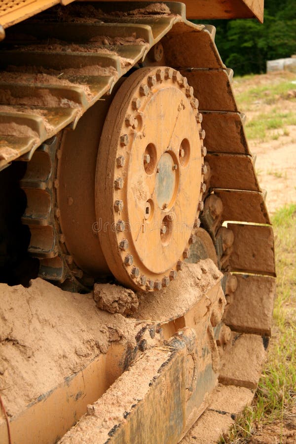 Bulldozer tread covered in dirt. Bulldozer tread covered in dirt