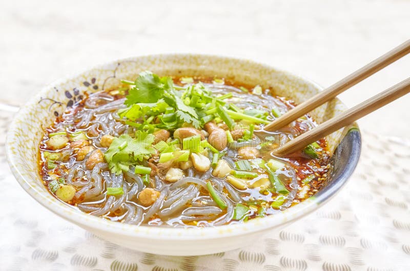 Spicy noodle soup with vegetables, herbs, peanuts and coriander, popular in Yunnan Province, shallow depth of field, China. Spicy noodle soup with vegetables, herbs, peanuts and coriander, popular in Yunnan Province, shallow depth of field, China.