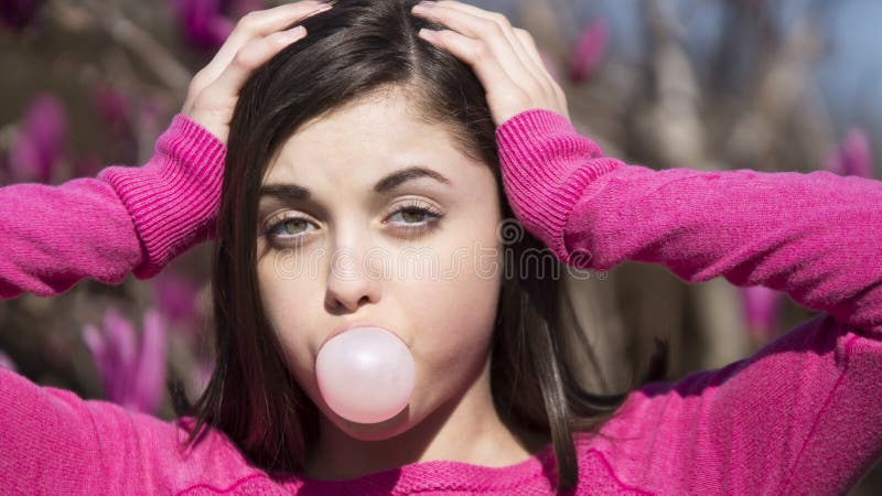 Пузырь bubblegum предназначенной для подростков девушки дуя стоковое изображение Пузырь bubblegum предназначенной для подростков девушки дуя стоковое изображение