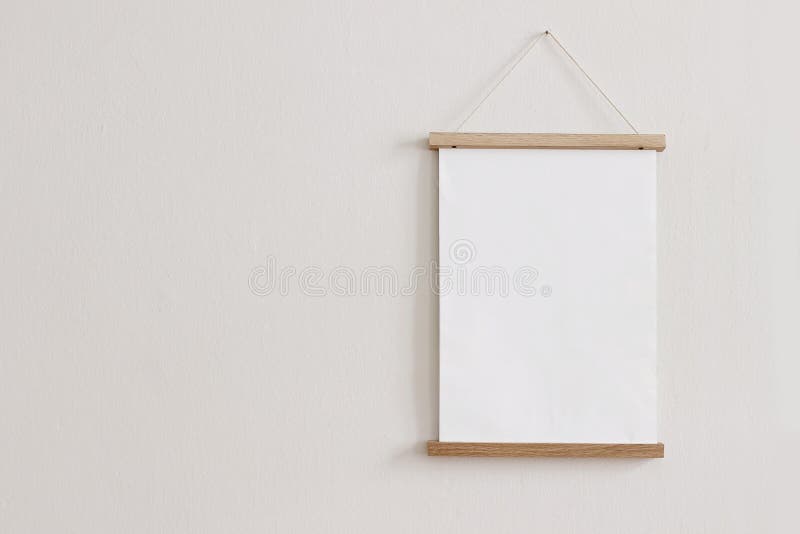 Blank wooden picture frame hanging on beige wall. Empty poster mockup for art display. Minimal interior design.Front view, copy space, no people. Blank wooden picture frame hanging on beige wall. Empty poster mockup for art display. Minimal interior design.Front view, copy space, no people.