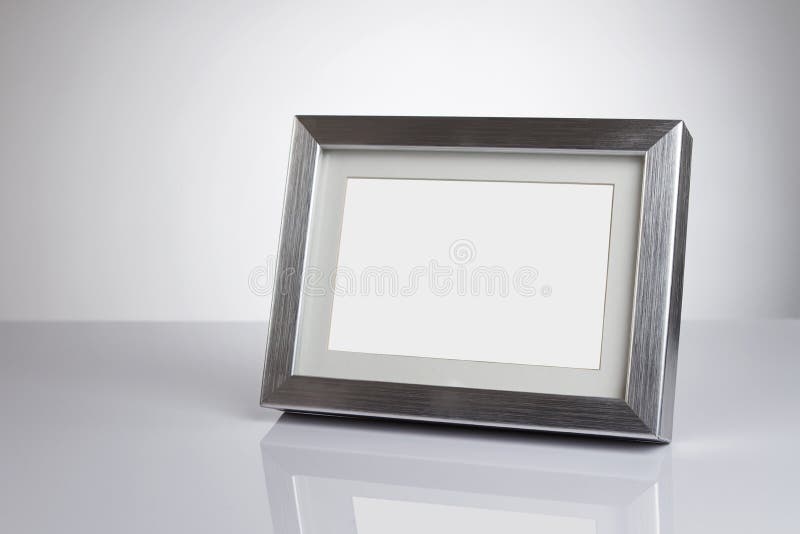 Blank silver picture frame at the desk with clipping path. Blank silver picture frame at the desk with clipping path