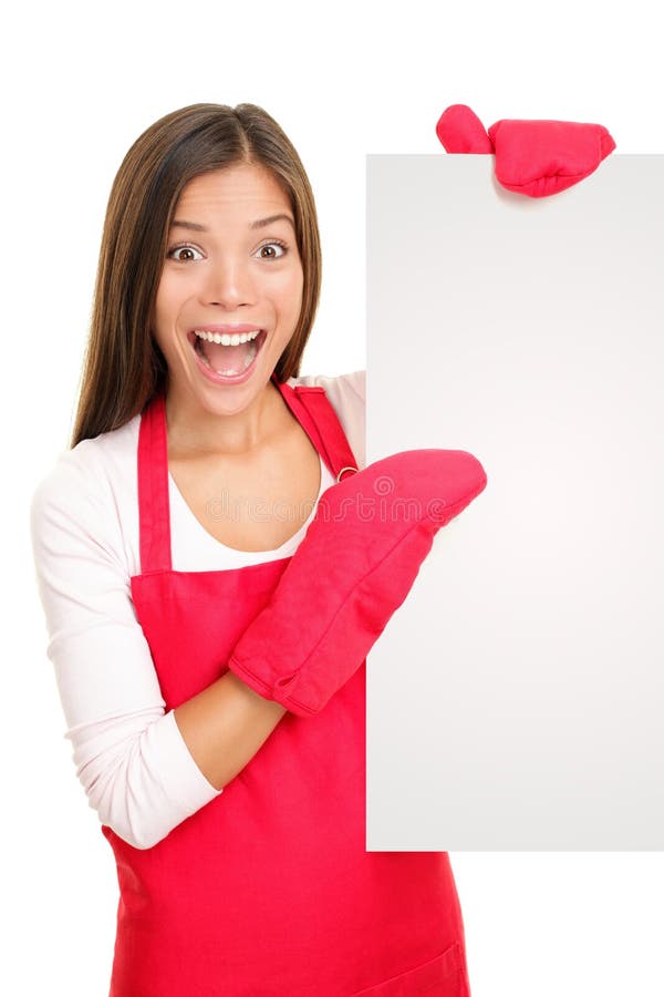 Baking woman showing blank poster sign wearing cooking mittens and red apron. Excited happy smiling mixed race Chinese Asian / white Caucasian woman isolated on white background. Baking woman showing blank poster sign wearing cooking mittens and red apron. Excited happy smiling mixed race Chinese Asian / white Caucasian woman isolated on white background.