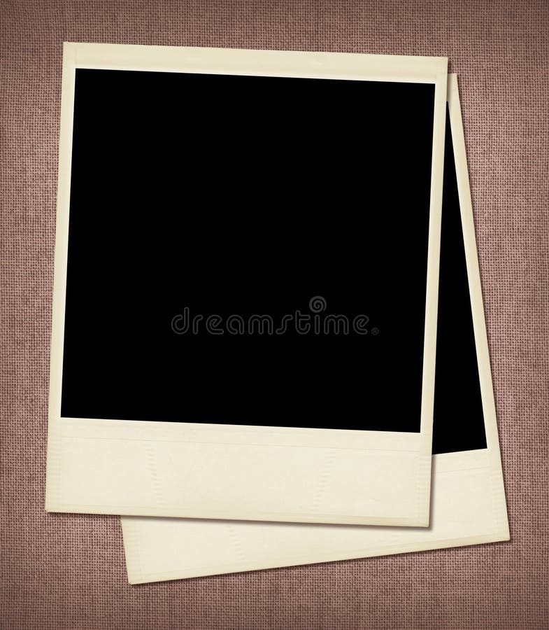 Two overlapping, blank, undeveloped polaroid instant film frames on woven fabric background. Two overlapping, blank, undeveloped polaroid instant film frames on woven fabric background.