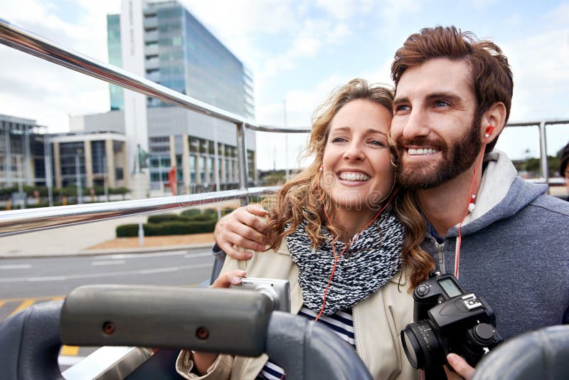 Tourist couple on open top bus tour guide around the city in vacation. Tourist couple on open top bus tour guide around the city in vacation