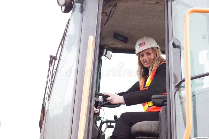 Female construction worker with a front loader machine. Female construction worker with a front loader machine