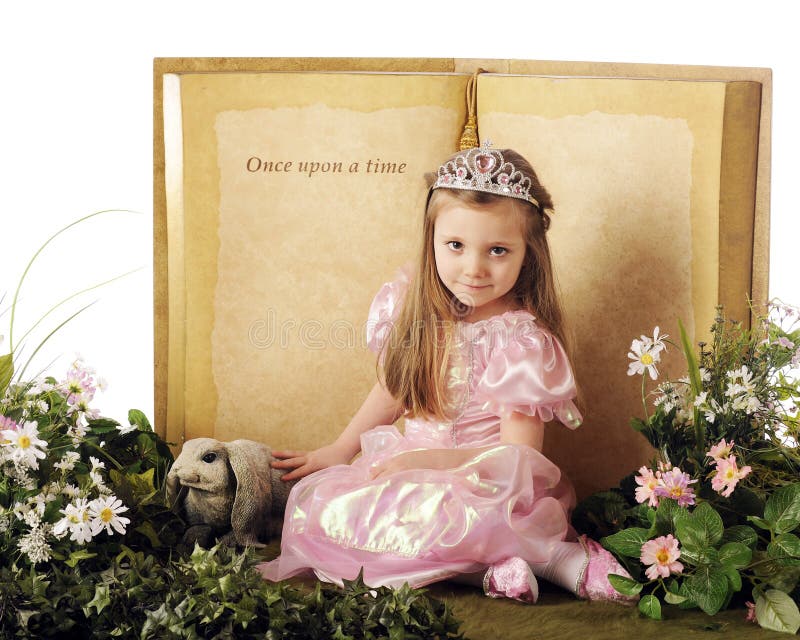 A beautiful little princes posed before a Once upon a time book and surrounded by flowers,foliage and a bunny. A beautiful little princes posed before a Once upon a time book and surrounded by flowers,foliage and a bunny.