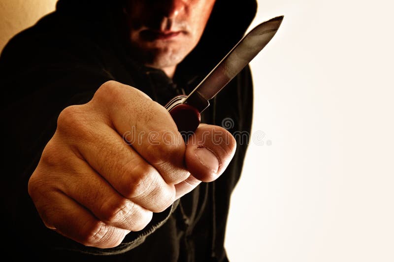 Crouching robber with small knife. Crouching robber with small knife