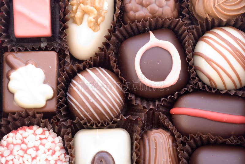 Close up of various colorful chocolat bonbons wrapped in brown paper. Close up of various colorful chocolat bonbons wrapped in brown paper