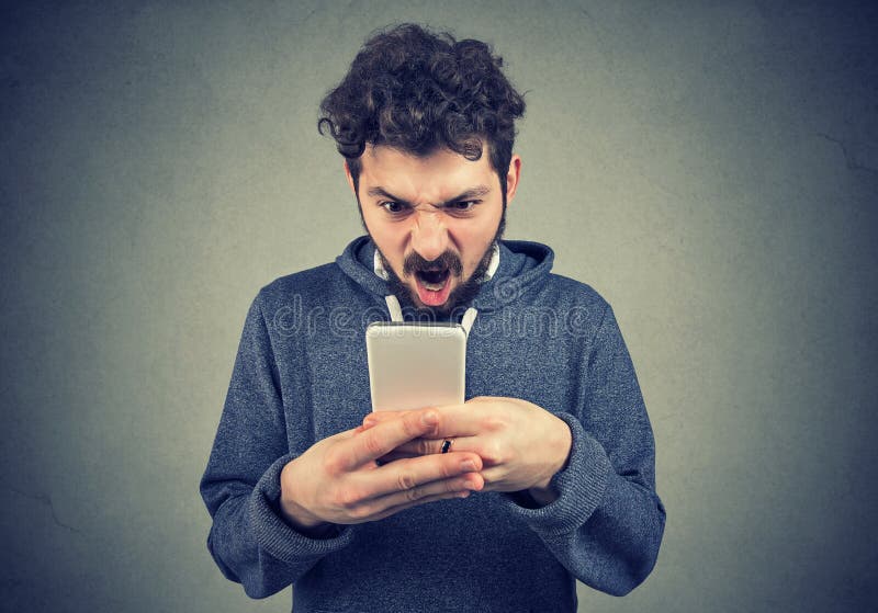 Разочарованный сердитый человек читая текстовое сообщение на его smartphone чувствуя расстроенный стоковое фото rf Разочарованный сердитый человек читая текстовое сообщение на его smartphone чувствуя расстроенный стоковое фото rf
