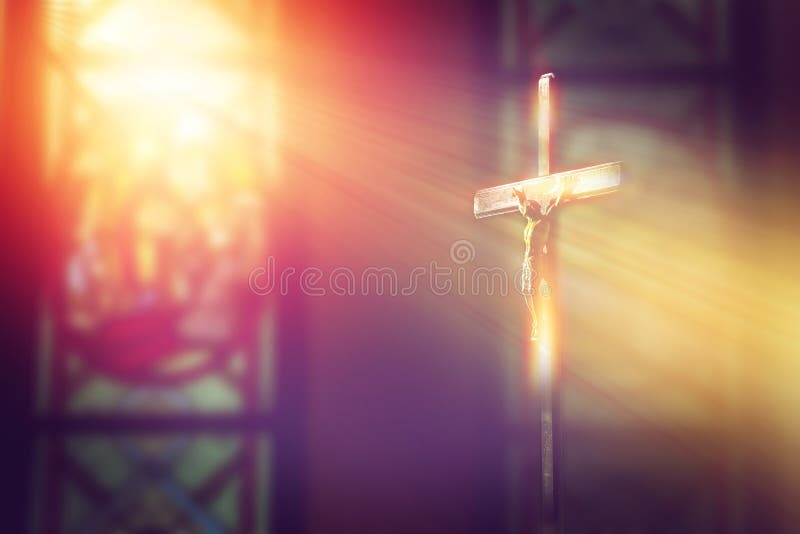 Crucifix, jesus on the cross in church with ray of light from stained glass. Crucifix, jesus on the cross in church with ray of light from stained glass