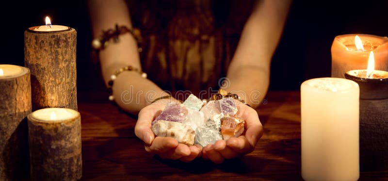 Female fortune teller holding healing stones, concept esoteric and life coaching. Female fortune teller holding healing stones, concept esoteric and life coaching
