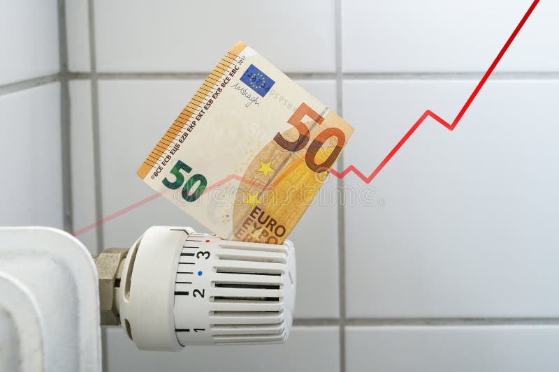 Rising curve of increasing costs for heat and energy, problem for home budgets symbolized by a banknote in the thermostat of a heating radiator, finance and money concept, copy space, selected focus. Rising curve of increasing costs for heat and energy, problem for home budgets symbolized by a banknote in the thermostat of a heating radiator, finance and money concept, copy space, selected focus