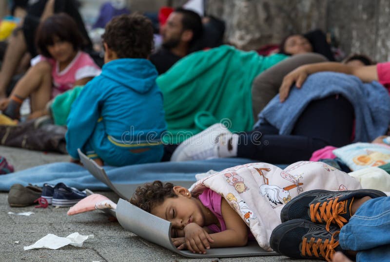 Refugee child sleeping on the ground. Refugees and migrants, most of them from Syria, are gathered at Keleti train station in Hungary, Sunday 30 august 2015. Thousands of syrian refugees are entering Hungary from Serbia, on their route to Germany. Refugee child sleeping on the ground. Refugees and migrants, most of them from Syria, are gathered at Keleti train station in Hungary, Sunday 30 august 2015. Thousands of syrian refugees are entering Hungary from Serbia, on their route to Germany.