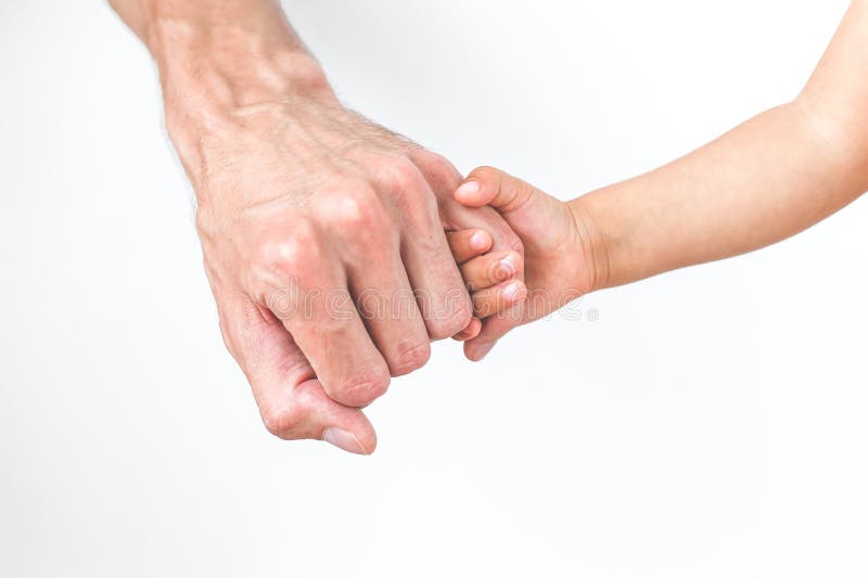 child holding dad's finger, close-up, face not visible, concept of fatherhood and father's day. child holding dad's finger, close-up, face not visible, concept of fatherhood and father's day.