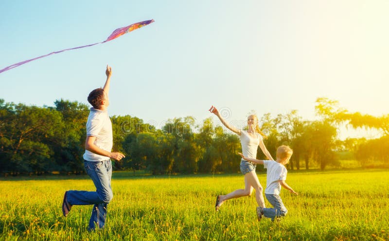 Happy family in summer nature. Dad, mom and son child flying a kite. Happy family in summer nature. Dad, mom and son child flying a kite