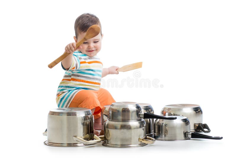 Ребёнок используя деревянные ложки для того чтобы грохнуть drumset лотков стоковые фотографии rf Ребёнок используя деревянные ложки для того чтобы грохнуть drumset лотков стоковые фотографии rf