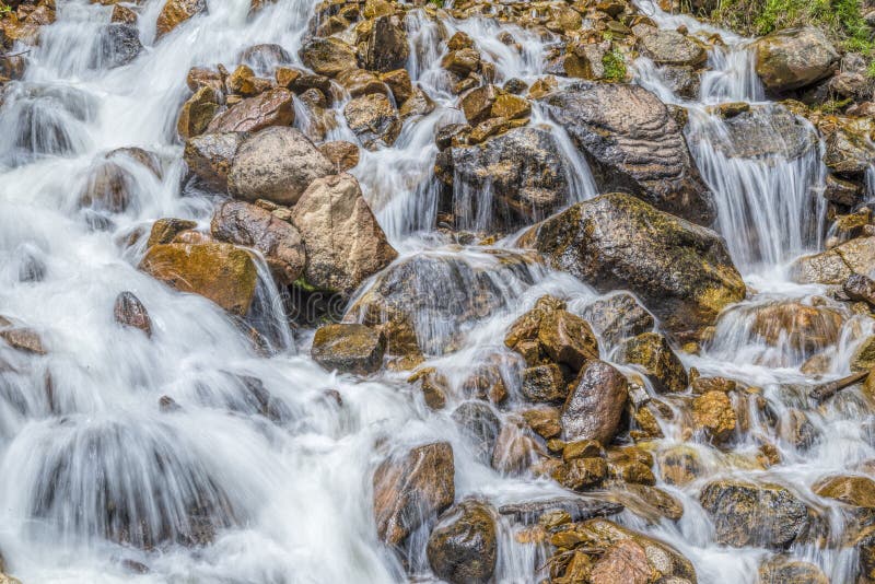 Waterfall gushing over the narrows in the rocky river bed of Fraser River, CO. Waterfall gushing over the narrows in the rocky river bed of Fraser River, CO.