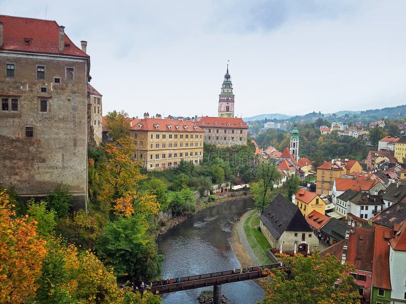 Cesky Krumlov, Czech Republic - October 1, 2014: Vltava River in Cesky Krumlov divides medieval town into two parts. You see the big castle in left side and small old buildings in right. In the front of picture, you may see a bridge is connected both parts. Old Cesky Krumlov is a UNESCO World Heritage Site. Cesky Krumlov, Czech Republic - October 1, 2014: Vltava River in Cesky Krumlov divides medieval town into two parts. You see the big castle in left side and small old buildings in right. In the front of picture, you may see a bridge is connected both parts. Old Cesky Krumlov is a UNESCO World Heritage Site