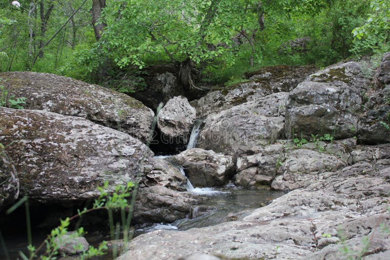 Река горы небольшой водопад на реке с кристально чистой водой, которая течет среди серых камней в лесу на стоковые фотографии rf