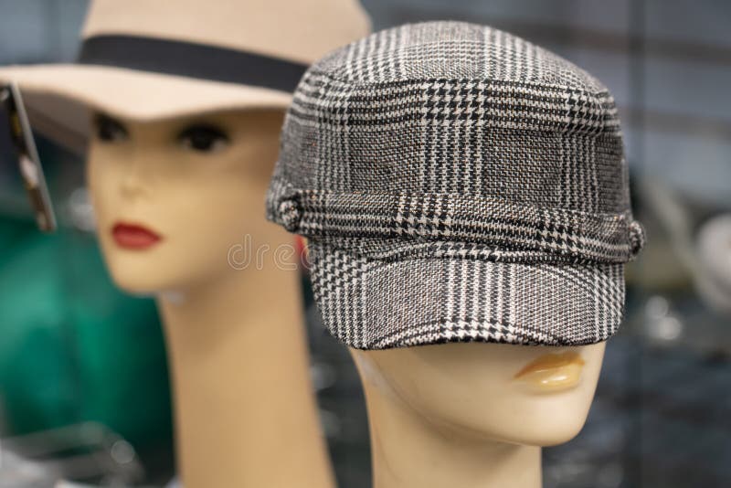 2 different retro 70s hats on mannequins the front one is a black and white plaid. 2 different retro 70s hats on mannequins the front one is a black and white plaid