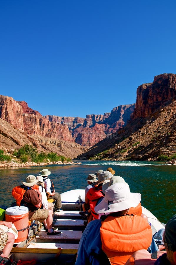 River rafters approach a rapid on the Colorado River in the Grand Canyon in Arizona on a sunny spring afternoon. River rafters approach a rapid on the Colorado River in the Grand Canyon in Arizona on a sunny spring afternoon