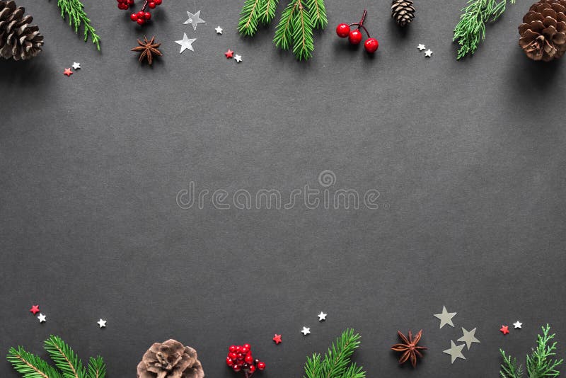 Christmas Composition on black background, copy space. Christmas ornaments, fir branches, silver and red stars. Flat lay, top view. Christmas Composition on black background, copy space. Christmas ornaments, fir branches, silver and red stars. Flat lay, top view