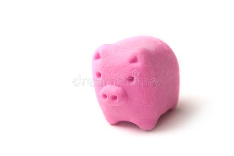 Closeup of pink erase in shaped piggy bank - debt erasing concept. Closeup of pink erase in shaped piggy bank - debt erasing concept