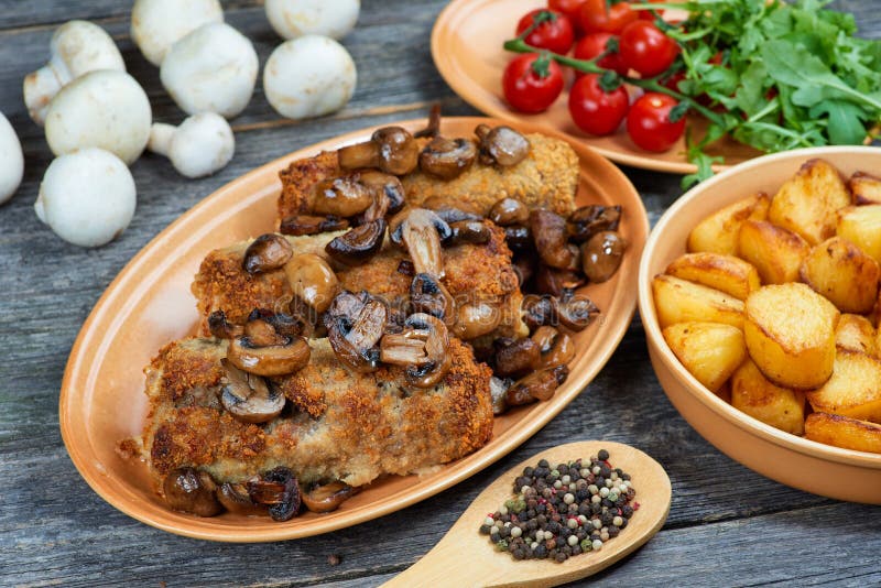 Рулада свинины с зажаренными в духовке грибами и картошками стоковое фото rf Рулада свинины с зажаренными в духовке грибами и картошками стоковое фото rf