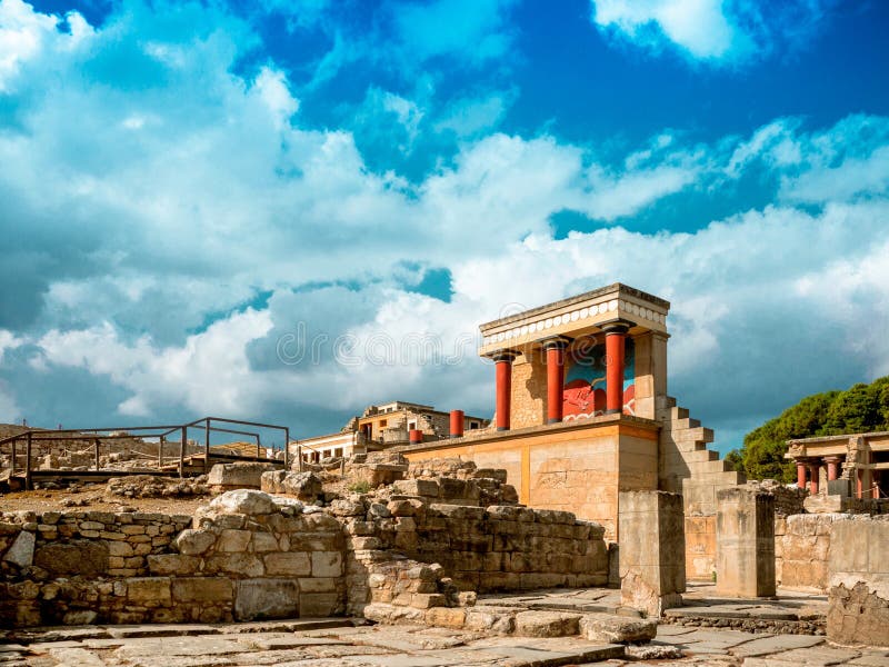 Ruins of ancient Greek palace of Knossos on Crete, where it is believed, in the maze the Minotaur was imprisoned. In the foreground real authentic ruins. In the background is the palace reconstruction archaeologist Arthur Evans (1851—1941). Ruins of ancient Greek palace of Knossos on Crete, where it is believed, in the maze the Minotaur was imprisoned. In the foreground real authentic ruins. In the background is the palace reconstruction archaeologist Arthur Evans (1851—1941).