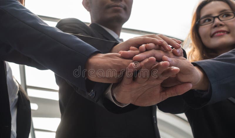 Business group hands overlapping to show cooperation. United teamwork concept. Business group hands overlapping to show cooperation. United teamwork concept.