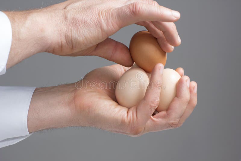 A male hands with four hens eggs. A male hands with four hens eggs.