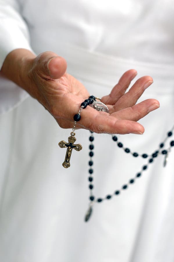 Hand of a holy woman reaching out, a catholic nun with a rosary crucifix. Hand of a holy woman reaching out, a catholic nun with a rosary crucifix.