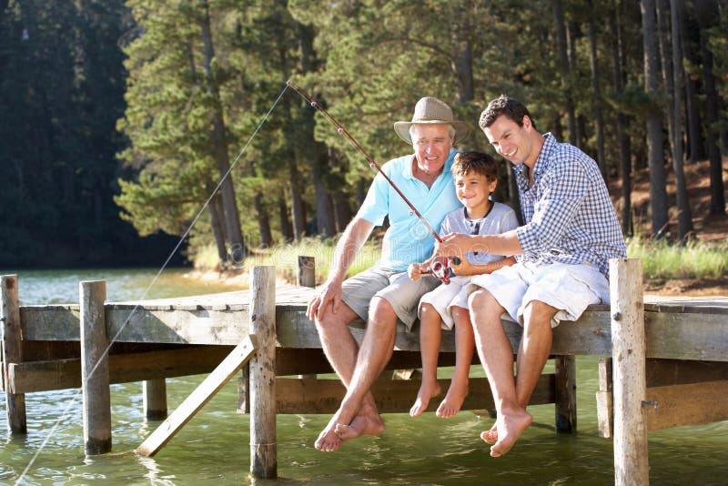 Father,son and grandson sat on pier fishing together. Father,son and grandson sat on pier fishing together