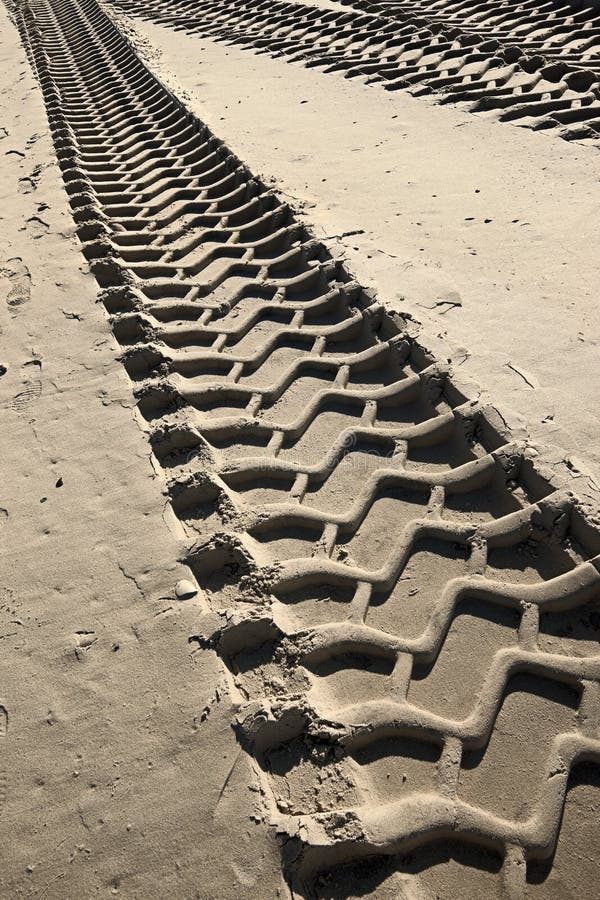 Tire tracks prints in sand on a beach. Tire tracks prints in sand on a beach