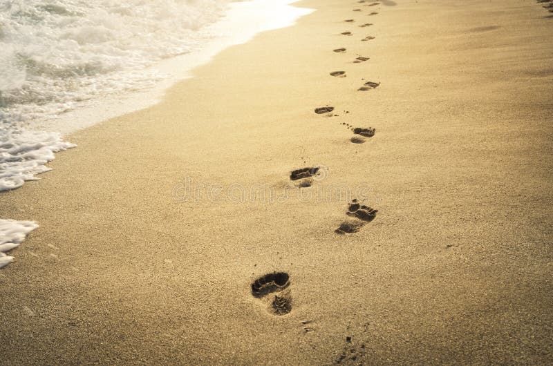 Footprints in the sand at sunset. Footprints in the sand at sunset