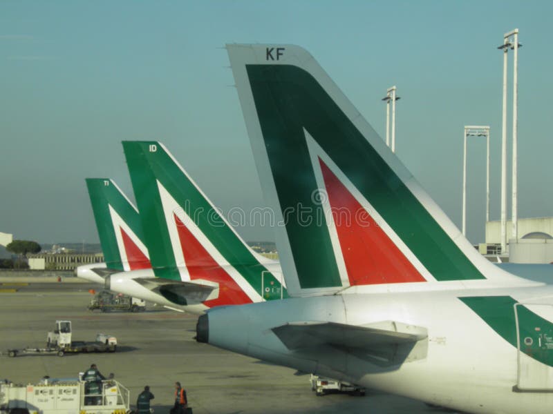 ROME, ITALY - NOVEMBER 11, 2011: Airplanes of the Italian national airlines Alitalia parked at the airport. ROME, ITALY - NOVEMBER 11, 2011: Airplanes of the Italian national airlines Alitalia parked at the airport