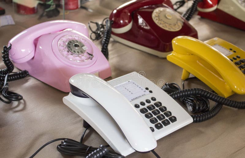 São Paulo / São Paulo / Brazil - 08 19 2018: Group of four or five vintage telephones colored with multiple and different styles at the flea market. São Paulo / São Paulo / Brazil - 08 19 2018: Group of four or five vintage telephones colored with multiple and different styles at the flea market